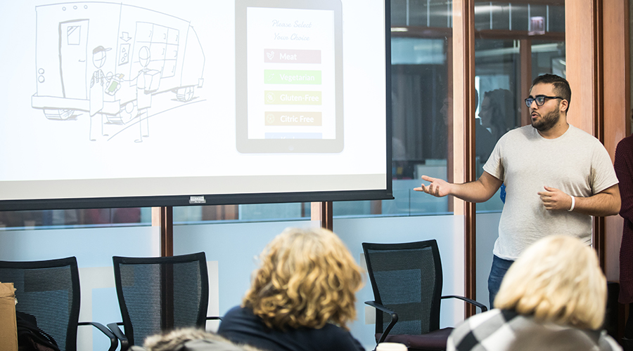 EDI students present solutions to Feeding America representatives.