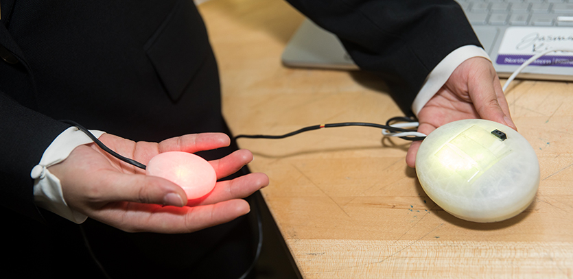 Jasmine Kim holds a prototype for her thesis project, Pebbie.