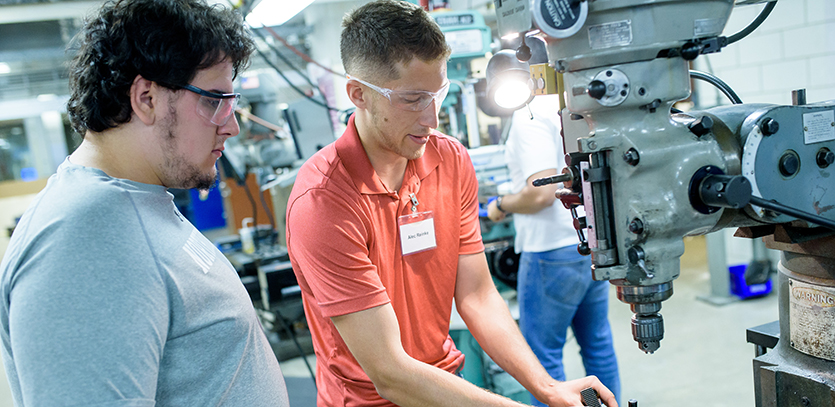 Alec Reinke (right) became a student-trainer in the Shop during his freshman year.