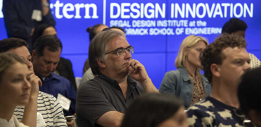 Engaged audience members listen to the panelists.