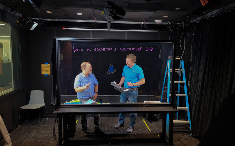 Professor Michael Peshkin and alum Kevin Koch interact with the new lightboard studio in Mudd Library.