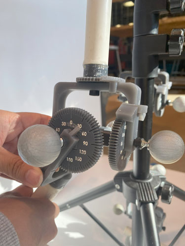 This image shows the ease of being able to alter the angle of one of OSCAR's joints utilizing the U-Joint system designed by the team. The gears of the U-Joint feature angle markings in increments of five degrees with the 30-degree markings noted through recessions in the 3D printed gears and hand painted by the team.