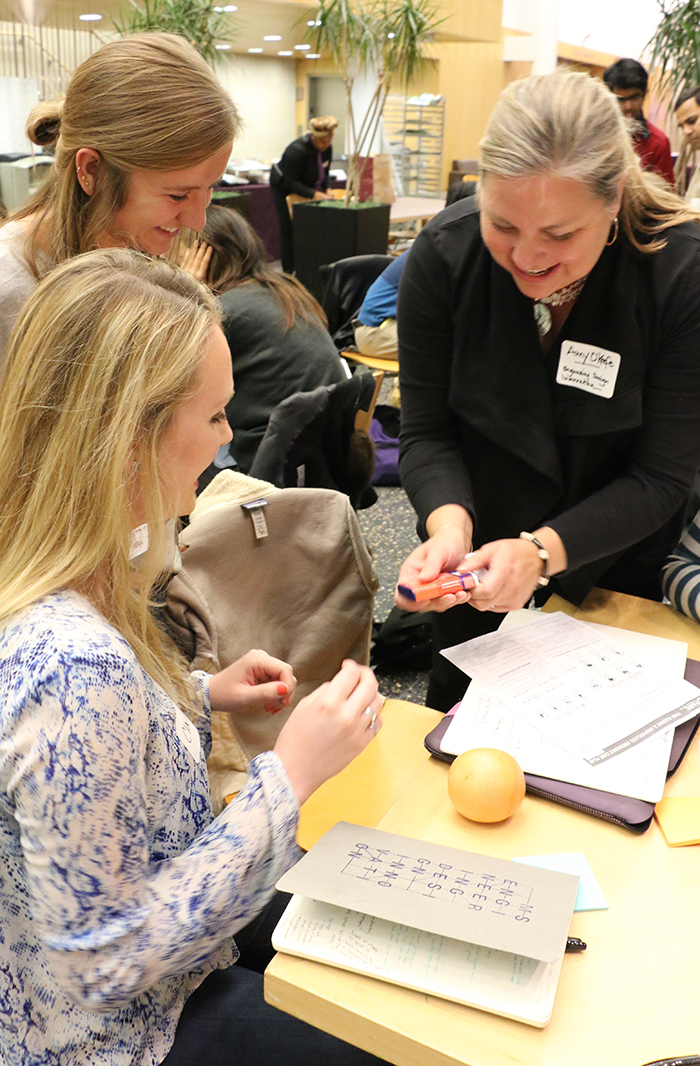 Amy O’Keefe, EDI instructor and associate director, demonstrates use of an epinephrine auto-injector for EDI student Delfina Sitar.