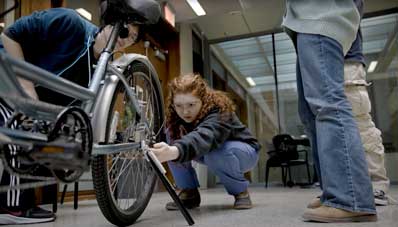 Students working on bike kickstand