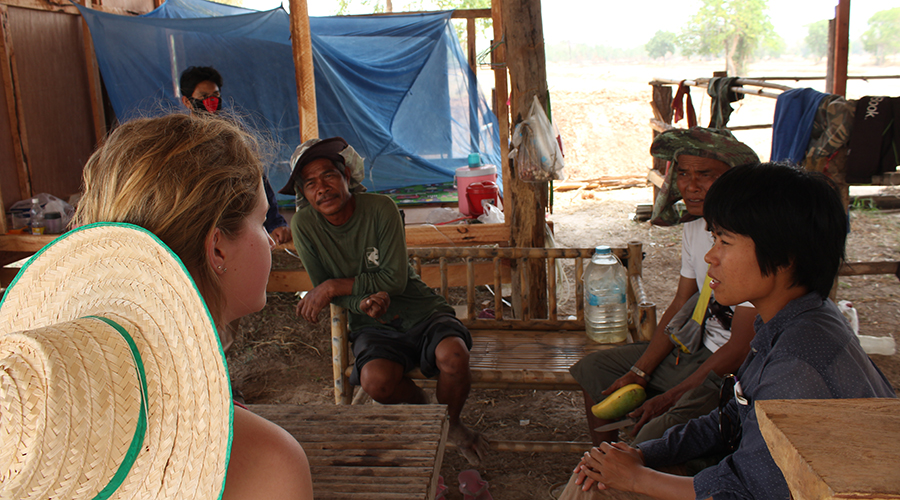 A member of the CattleTECH team speaks with farmers in Thailand.