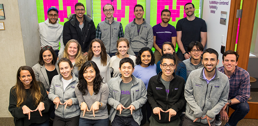 MMM students pose in front of Post-it art during MMM Innovation Day.